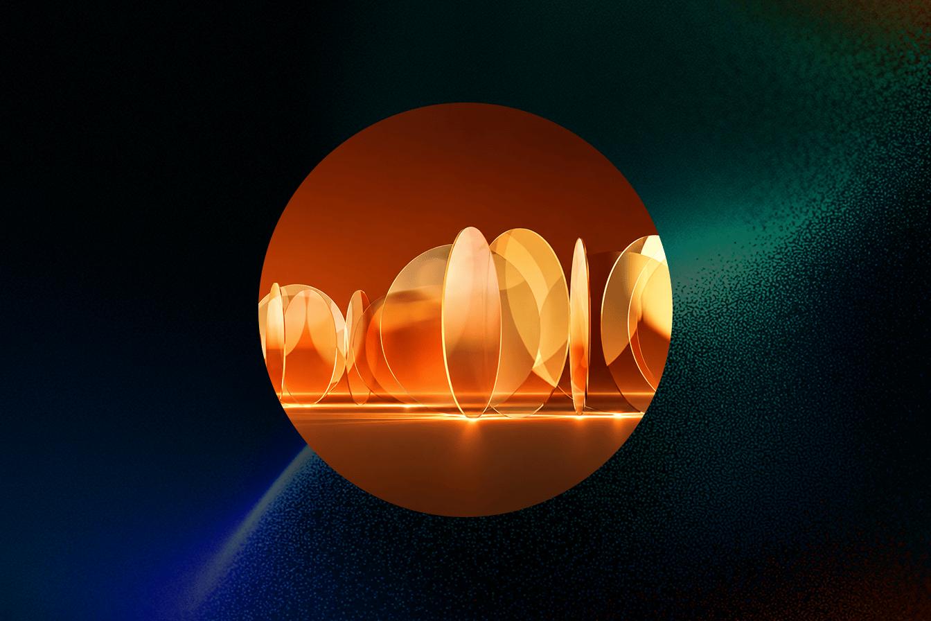 Glowing translucent orange discs standing in a row on a reflective surface