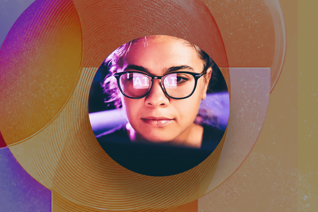 Close-up of a person wearing glasses with the letters AI reflected in the lenses